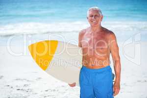 Mature man posing with a surfboard