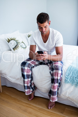 Young man typing a text message on phone