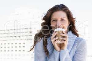 Happy young woman having coffee
