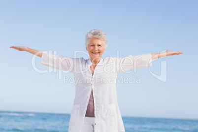 Casual senior woman with arms outstretched