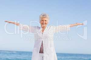 Casual senior woman with arms outstretched