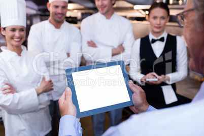 Restaurant manager briefing to his kitchen staff
