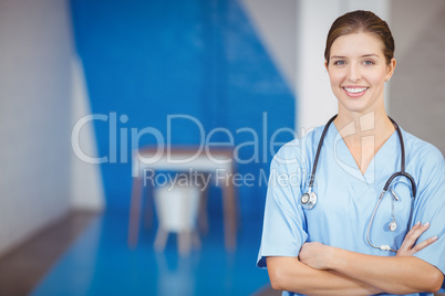 Portrait of beautiful smiling female doctor with arms crossed