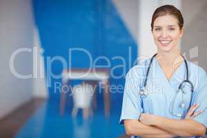 Portrait of beautiful smiling female doctor with arms crossed