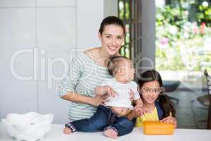 Portrait of smiling mother with children