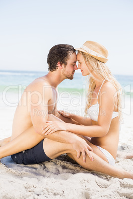Young couple sitting face to face and romancing