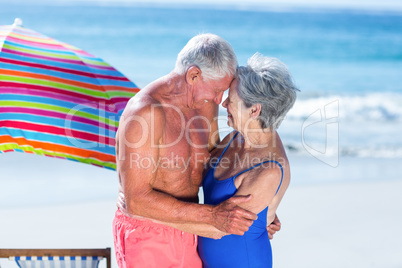 Cute mature couple hugging on the beach