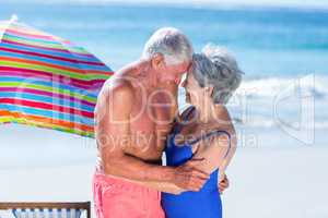 Cute mature couple hugging on the beach