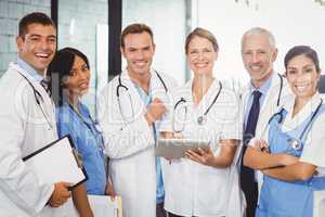 Portrait of medical team standing with digital tablet and clipbo