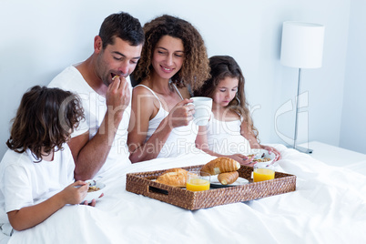 Family having breakfast in bed