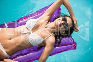 Young woman relaxing on inflatable raft