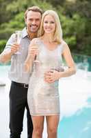 Smiling couple showing champagne flutes