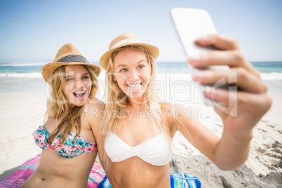 Two friends in bikini taking a selfie