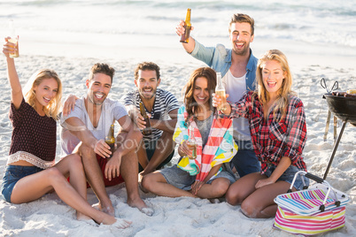 Friends drinking beer at the beach