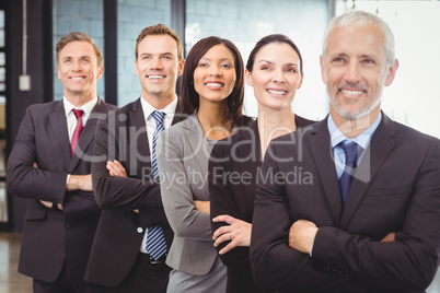 Businesspeople standing with arms crossed