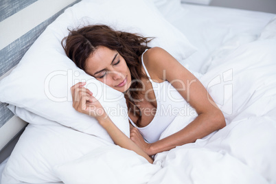 Beautiful woman sleeping on bed at home