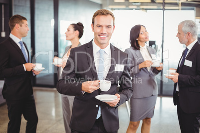 Portrait of businessman having tea during break time