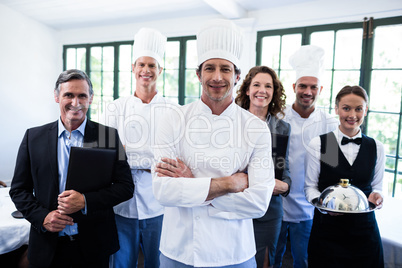 Happy restaurant team standing together in restaurant