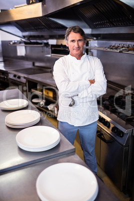 Smiling chef with hands crossed in the kitchen