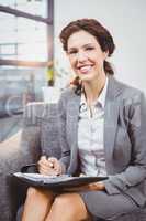 Businesswoman with diary sitting at office