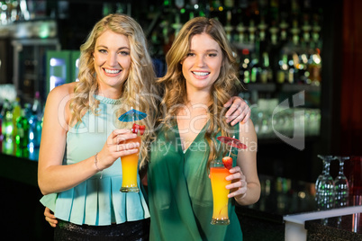 Happy friends drinking cocktails