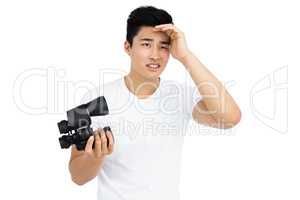 Young man holding binoculars