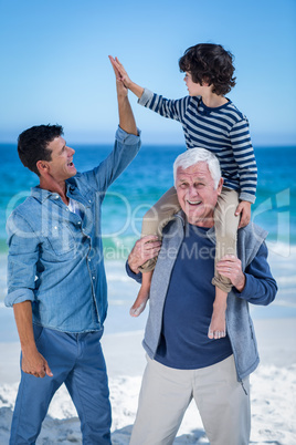 Male family members playing at the beach