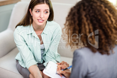 Woman discussing problems with female psychologist