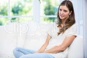 Woman sitting on sofa and arguing with partner