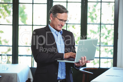 Smiling businessman using a laptop