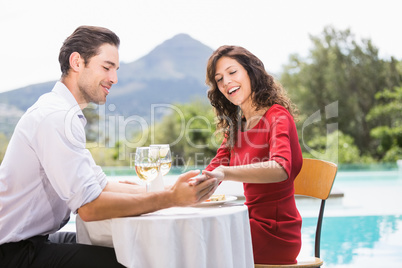 Couple looking at engagement ring