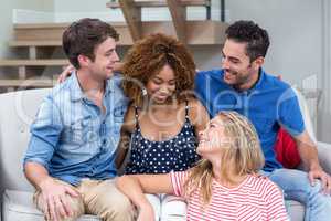 Young friends sitting on sofa