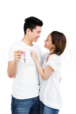 Happy young couple showing key