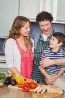 Happy parents with son in kitchen