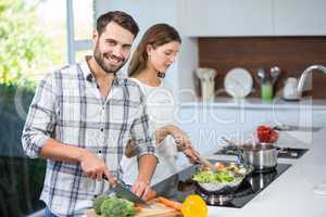 Man helping woman in preparing food at home