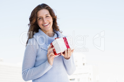 Happy young woman holding gift