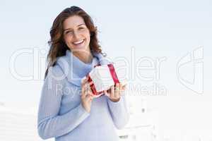 Happy young woman holding gift