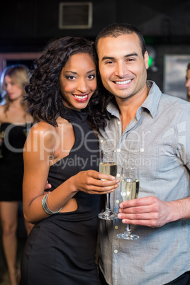 Smiling couple drinking champagne