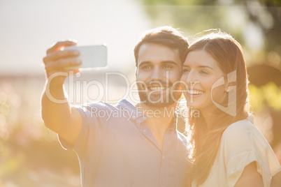 Happy couple clicking selfie with smart phone