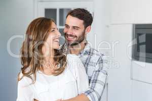 Young couple embracing at home