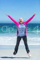 Happy mature woman outstretching her arms
