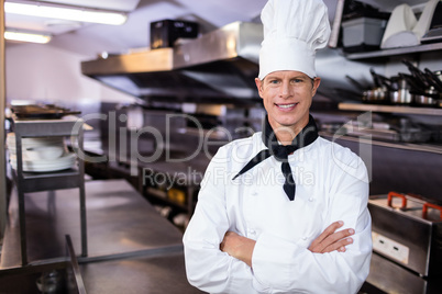 Portrait of confident chef standing in kitchen