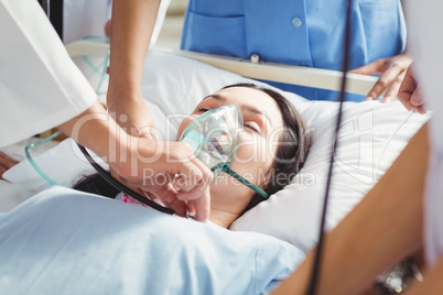 Doctor putting an oxygen mask on patient