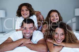 Portrait of family lying on top of each other