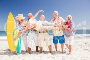 Senior friends holding senior woman