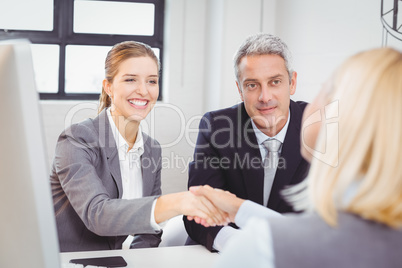 Smart business people handshaking with client