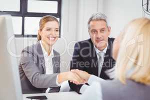 Smart business people handshaking with client