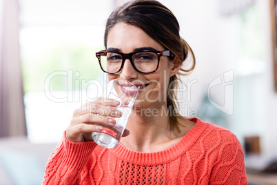 Portrait of beautiful young woman drinking water