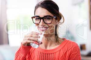 Portrait of beautiful young woman drinking water