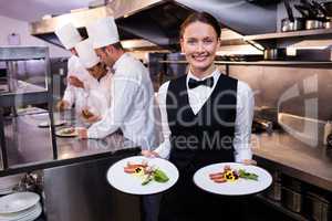 Waitress showing dishes to the camera
